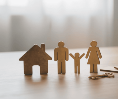 3 women and 2 men sitting on green grass field during daytime